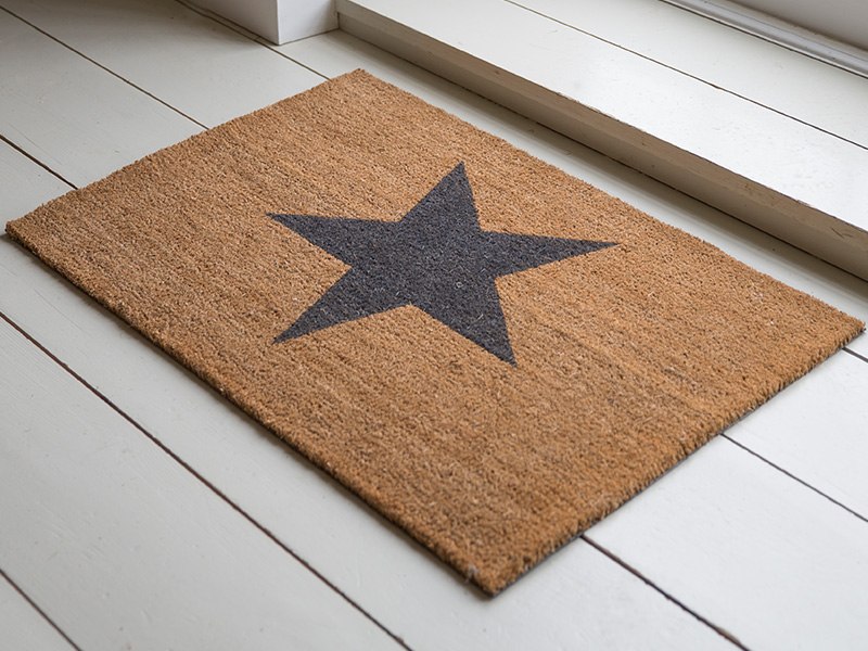 Star Doormat on white wooden floor