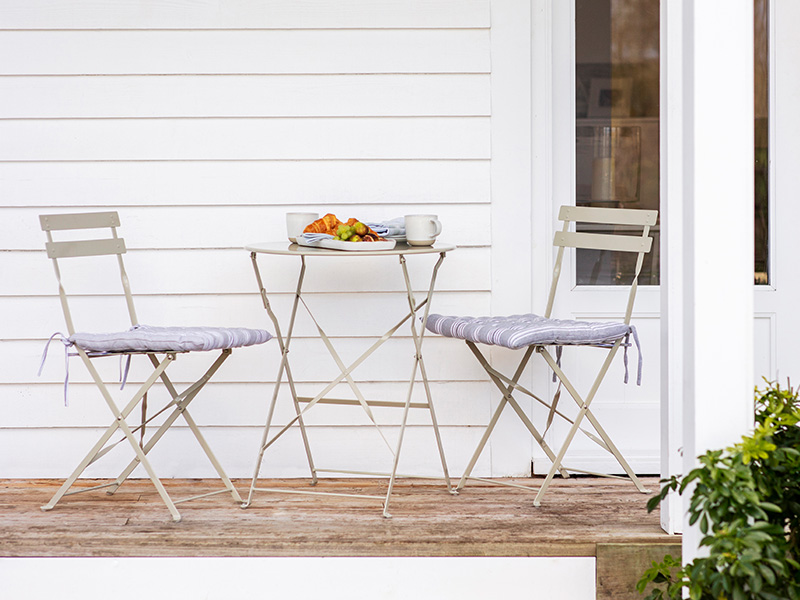 Small Bistro set in Clay on wood-decked patio