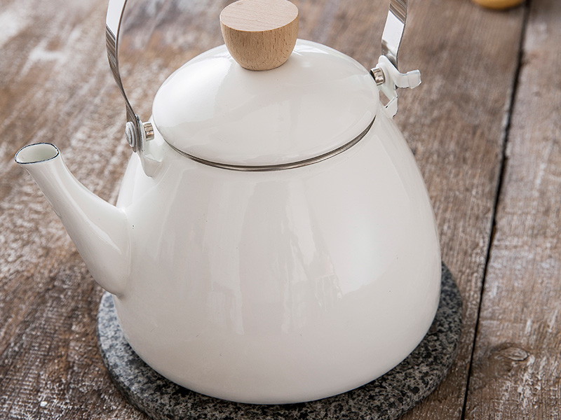 Warm White Stove Kettle on Wooden Surface
